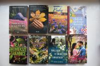 Okładki nowości książkowych na parapecie.