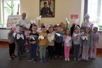 Grupa dzieci pozuje do zdjęcia w bibliotece